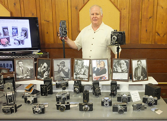 Kevin Murray and his extensive antique camera collection.
